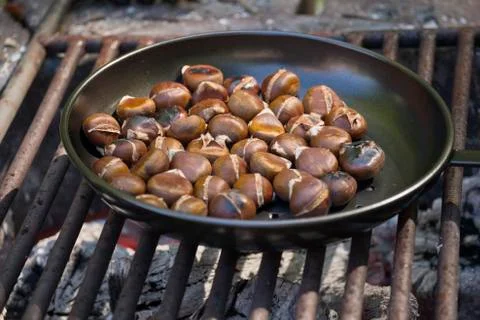 Chestnuts roasting on an open fire Stock Photos