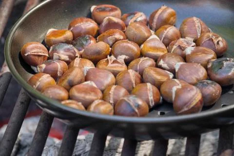 Chestnuts roasting on an open fire Stock Photos
