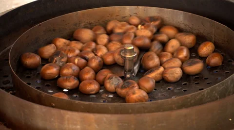 Chestnuts roasting on street vendor's stall Stock Footage