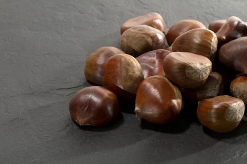 Chestnuts on slate Stock Photos