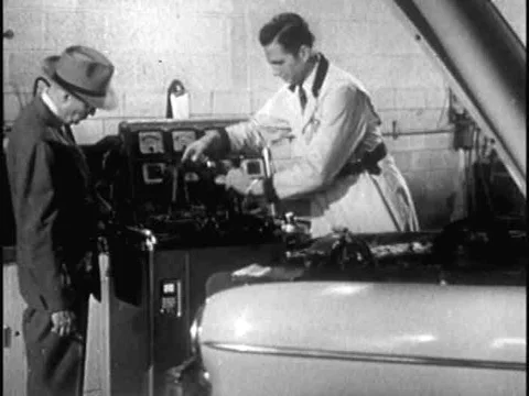 A Chevrolet serviceman uses a machine to check the components of a customer's Stock Footage 74973846