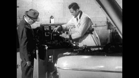 A Chevrolet serviceman uses a machine to check the components of a customer's Stock Footage 139699736