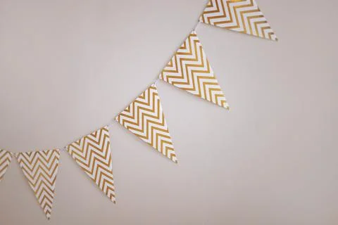Chevron patterned bunting on white wall 库存照片
