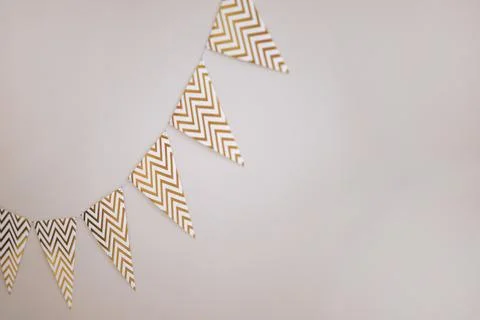 Chevron patterned bunting on white wall 库存照片