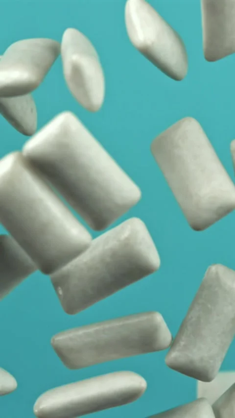 Chewing gum flies on a blue background. Filmed on a high-speed camera at 1000 Stock Footage 335380315