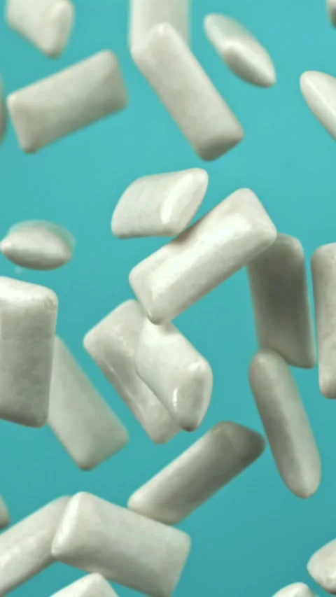 Chewing gum flies on a blue background. Filmed on a high-speed camera at 1000 Stock Footage 335385214