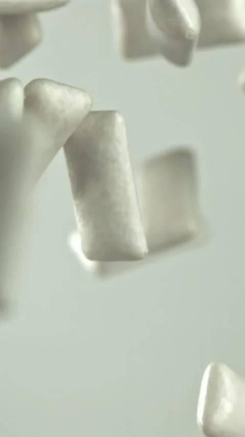 Chewing gum flies on a white background. Filmed on a high-speed camera at 1000 Stock Footage 335376729