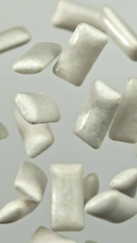 Chewing gum flies on a white background. Filmed on a high-speed camera at 1000 Stock Footage 335381892