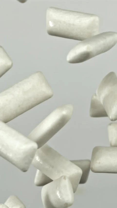 Chewing gum flies on a white background. Filmed on a high-speed camera at 1000 Stock Footage 335385130