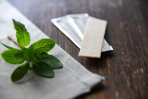 Chewing Gum with Mint Leafs on Table Stock Photos