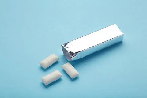 Chewing gum package on blue background. Stock Photos