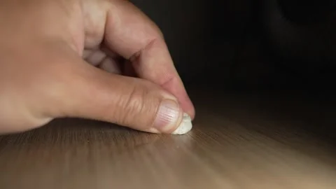 Chewing gum is stuck on the table Stock Footage 316584323