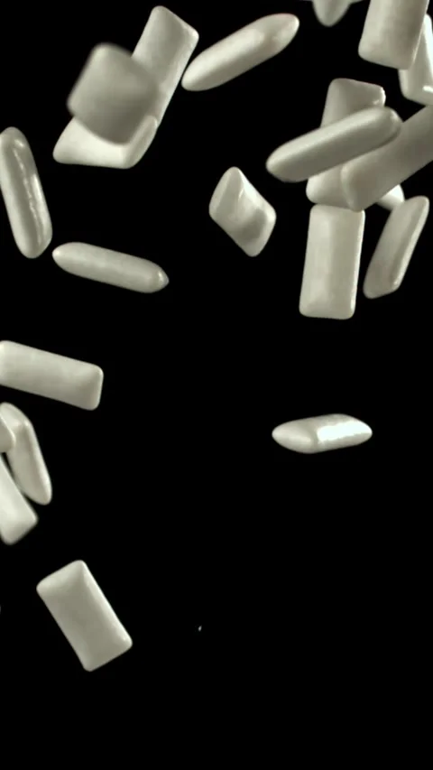 Chewing gums fly on a black background. Filmed on a high-speed camera at 1000 Stock Footage 335376860