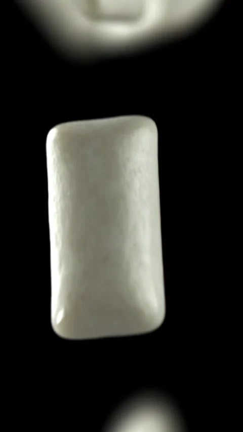 Chewing gums fly on a black background. Filmed on a high-speed camera at 1000 Stock Footage 335379763