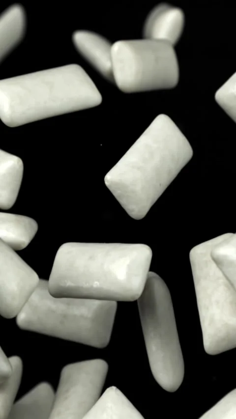 Chewing gums fly on a black background. Filmed on a high-speed camera at 1000 Stock Footage 335381600