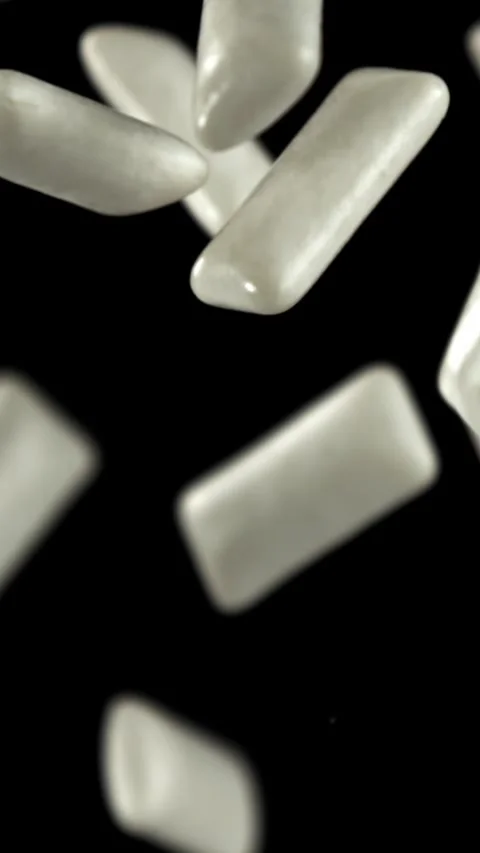 Chewing gums fly on a black background. Filmed on a high-speed camera at 1000 Stock Footage 335381749