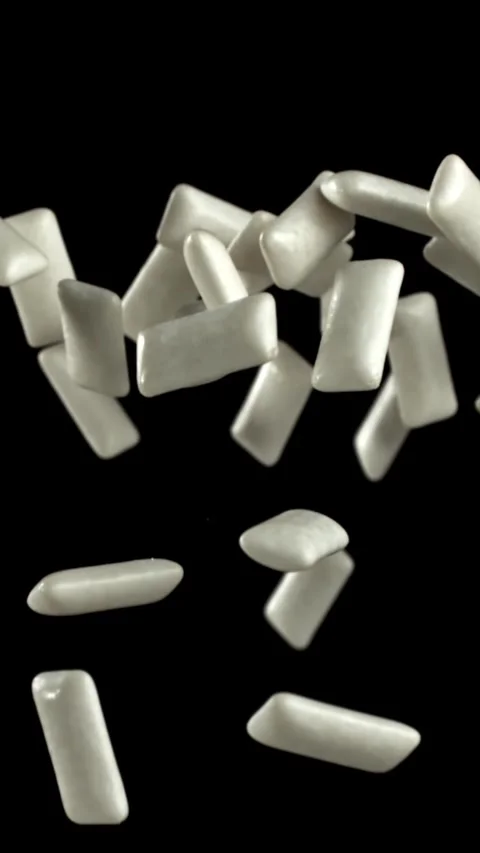 Chewing gums fly on a black background. Filmed on a high-speed camera at 1000 Stock Footage 335381785