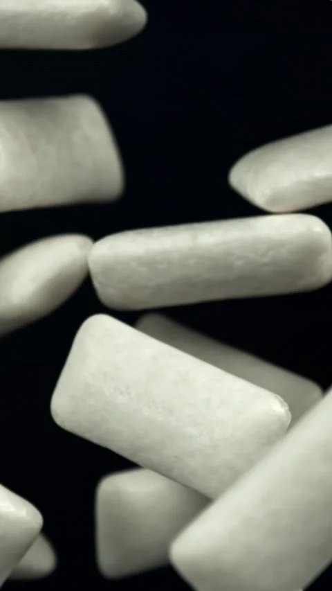 Chewing gums fly on a black background. Filmed on a high-speed camera at 1000 Stock Footage 335383287