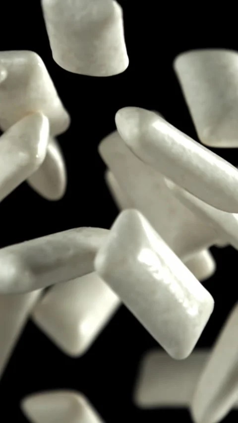 Chewing gums fly on a black background. Filmed on a high-speed camera at 1000 Stock Footage 335385105