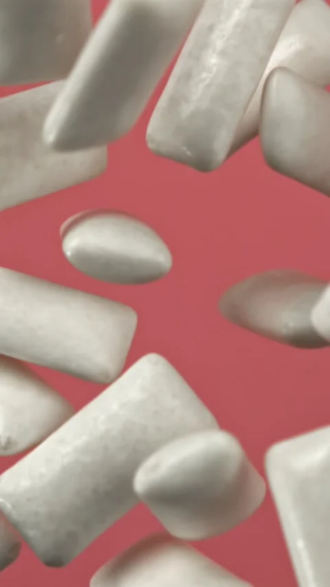 Chewing gums fly on a pink background. Filmed on a high-speed camera at 1000 fps Stock Footage 335380751
