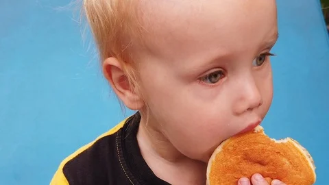 Chews a two-year-old boy close-up, in slow motion. Stock Footage 105594730