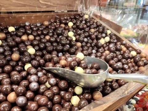 Chewy brown marmalade on the shelf in the candy store, in the store Stock Photos