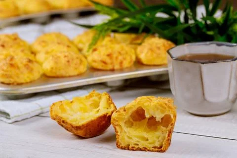 Chewy cheese bread called chipa with coffee on wooden table. Stock Photos
