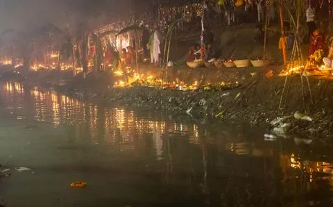 Chhath puja celebration scene with devotee holding daali offerings and diya.. Фото