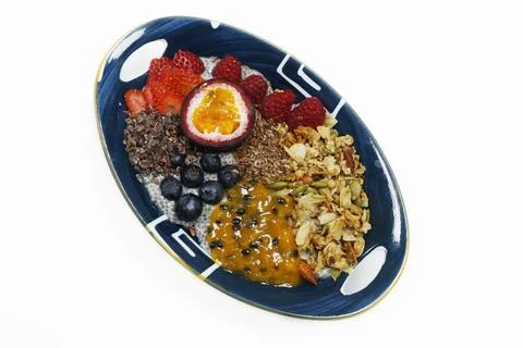 Chia pudding breakfast with passion fruit, nuts and berries isolated with w.. Stock Photos