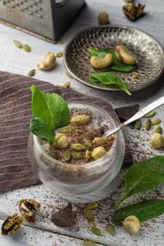 Chia pudding with cocoa, spinach and nuts in almond milk Stock Photos