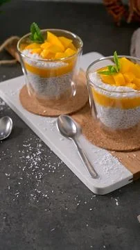 Chia Pudding with Fresh Mango and Coconut Shavings in Glass Cups Stock Photos