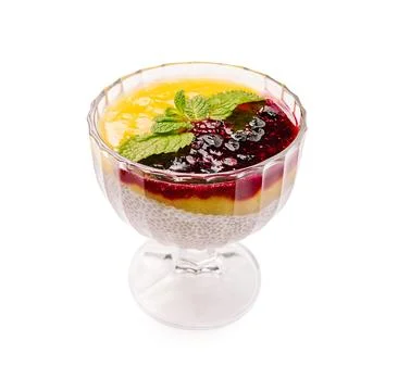 Chia pudding with fruit layers in a clear glass cup on white background Stock Photos