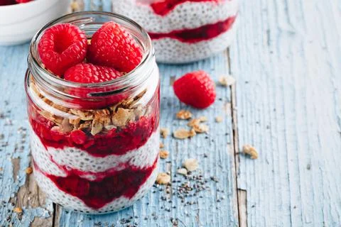 Chia Pudding. Healthy vanilla raspberry chia pudding in a glass jar with fres Stock Photos