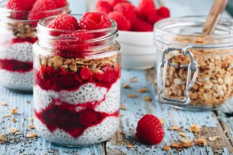 Chia Pudding. Healthy vanilla raspberry chia pudding in a glass jar with fres Stock Photos