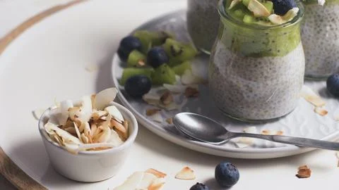 Chia pudding jars with kiwi and coconut flakes Stock Photos