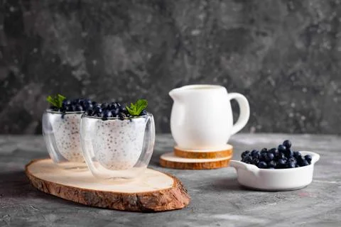 Chia pudding with mint in glasses on a wooden stand Stock Photos