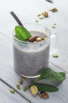 Chia pudding with spinach and nuts in almond milk Stock Photos
