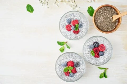 Chia pudding, top view, copy space, fresh berries raspberries, blueberries Stock Photos