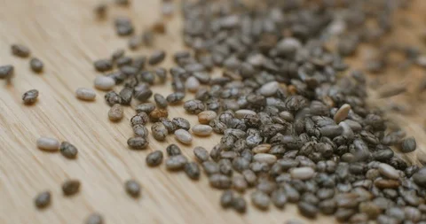 Chia seed falling and rotating macro studio Stock Footage 101468436