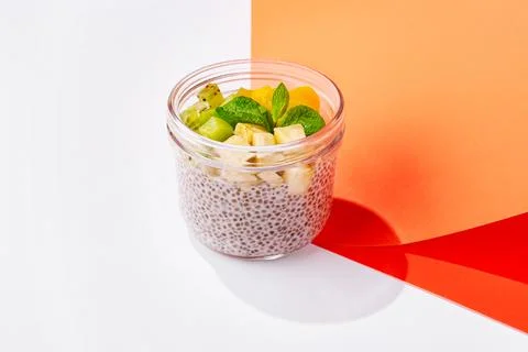 Chia seed pudding with fresh fruit placed on a colorful background Stock Photos