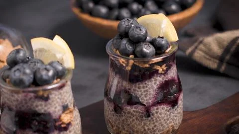 Chia seed pudding jars with fresh blueberries and lemon slices Stock Photos