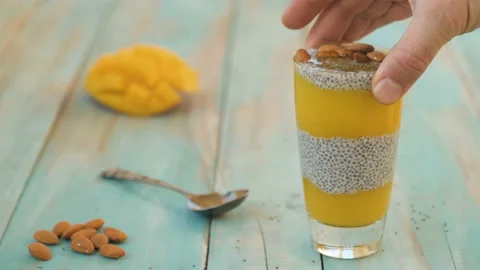 Chia seed pudding with mango and almond Stock Footage 152038546