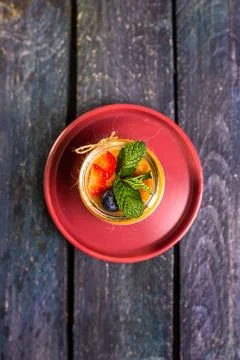Chia Seed Pudding with Mango and Berries in Glass Jar on Red Plate Stock Photos