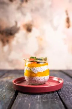 Chia Seed Pudding with Mango and Berries in Glass Jar on Red Plate Stock Photos