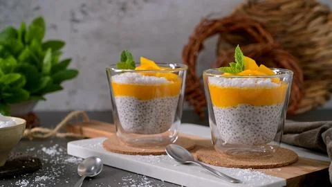 Chia seed pudding with mango and coconut in glass cups Stock Photos