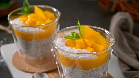 Chia seed pudding with mango and coconut in glass cups Stock Photos