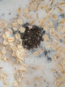 Chia seeds and oat flakes Stock Photos
