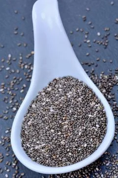 Chia seeds in a ceramic spoon Stock Photos