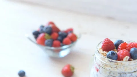 Chia seeds pudding with berries in jar on wooden table. Vegetarian concept. Stock Footage 64948332