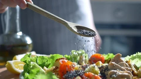 Chia seeds in wooden spoon close up. seeds falling slow motion, healthy food Stock Footage 252509554